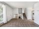 Open-concept living room features carpet floors, a cozy fireplace and staircase leading to an upper level at 5372 E 108Th Pl, Thornton, CO 80233