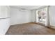 Carpeted living room with a large window providing natural light and views of the landscaped exterior at 5372 E 108Th Pl, Thornton, CO 80233