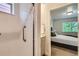 Bathroom leading into the bedroom, featuring a glass door shower with modern bathroom fixture at 65 Avocet Ct, Longmont, CO 80501