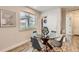 Dining area featuring a glass table, modern decor, and an in-unit laundry closet at 65 Avocet Ct, Longmont, CO 80501