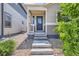 Close-up of front entrance with concrete steps leading up to a cozy, covered porch and inviting front door at 65 Avocet Ct, Longmont, CO 80501