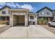 This home features a spacious garage and driveway with ample parking and curb appeal at 65 Avocet Ct, Longmont, CO 80501