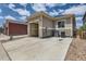 Exterior view of a home featuring a spacious garage with ample parking and convenient access at 65 Avocet Ct, Longmont, CO 80501