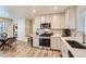 Modern kitchen features stainless steel appliances, light wood floors, and bright white cabinets at 65 Avocet Ct, Longmont, CO 80501