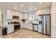 Bright kitchen with white cabinetry, stainless steel appliances, and wood-look flooring, creating a modern aesthetic at 65 Avocet Ct, Longmont, CO 80501
