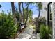 Landscaped backyard with a walkway, lush greenery, and trees providing shade at 2805 S Sherman St, Englewood, CO 80113