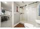 Basement bathroom featuring a shower with clear glass door and wood look flooring at 2805 S Sherman St, Englewood, CO 80113