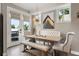 Bright dining room with French doors, stylish chandelier and unique upholstered seating at 2805 S Sherman St, Englewood, CO 80113