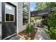 Modern home exterior showcasing a stone accent wall, a dark front door, and a covered patio area at 2805 S Sherman St, Englewood, CO 80113