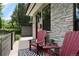 Inviting front porch with red chairs and stone facade at 2805 S Sherman St, Englewood, CO 80113