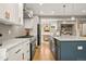 Modern kitchen showcasing white cabinetry, contrasting island, and open layout to living spaces at 2805 S Sherman St, Englewood, CO 80113