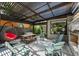 Covered patio with stone fireplace, ceiling fan, and comfortable outdoor seating at 2805 S Sherman St, Englewood, CO 80113