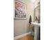 Chic powder room featuring a pedestal sink, decorative mirror and unique wall art at 2805 S Sherman St, Englewood, CO 80113