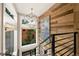 Staircase with metal railing, wood accent wall, and geometric light fixture at 2805 S Sherman St, Englewood, CO 80113