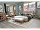 Bright bedroom with hardwood floors, neutral tones and a large mirror providing spaciousness at 7755 E Quincy Ave # 203A6, Denver, CO 80237