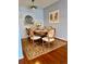 Charming dining room featuring a table, six chairs, rug, and artwork with blue walls at 7755 E Quincy Ave # 203A6, Denver, CO 80237