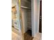 Pantry area with shelves located just off the kitchen with access to stove, tile floors, and a door at 7755 E Quincy Ave # 203A6, Denver, CO 80237