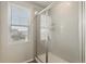 Modern bathroom featuring glass-enclosed shower and bright window at 16369 Alberta Dr, Parker, CO 80134