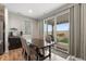 A formal dining room with a dining table, hardwood floors, and a sliding glass door at 16369 Alberta Dr, Parker, CO 80134