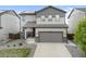 Two-story home with stone accents, solar panels, a two-car garage, and a well-maintained front yard at 16369 Alberta Dr, Parker, CO 80134