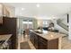 Spacious kitchen with large island, stainless appliances, and access to the outdoor patio and living area at 16369 Alberta Dr, Parker, CO 80134