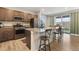 Open kitchen features stainless steel appliances, granite countertops, and a large island with seating at 16369 Alberta Dr, Parker, CO 80134