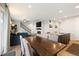 Bright and open living space with modern decor, a fireplace, and a large dining table with ample seating at 16369 Alberta Dr, Parker, CO 80134