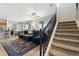 View of the living room and staircase showing hardwood floors and large area rug at 16369 Alberta Dr, Parker, CO 80134