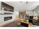 The living room shows a fireplace, television, laminate floors, and open floor plan at 16369 Alberta Dr, Parker, CO 80134