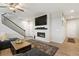 The living room has a modern fireplace, ceiling fan, staircase, and beautiful laminate wood flooring at 16369 Alberta Dr, Parker, CO 80134