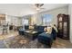 The living room features a large sofa, hardwood floors, ceiling fan, and sliding glass doors at 16369 Alberta Dr, Parker, CO 80134
