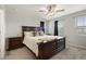 Well-lit main bedroom features a large bed, dark wood furniture and a view of the neighborhood at 16369 Alberta Dr, Parker, CO 80134
