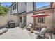 Backyard patio featuring seating area, grill, and an air conditioning unit for outdoor comfort at 6792 E Briarwood Dr, Centennial, CO 80112