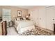 Comfortable bedroom with neutral walls, plush carpeting, a queen bed, and double closet doors at 6792 E Briarwood Dr, Centennial, CO 80112