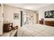 Bright bedroom featuring sliding glass doors leading to a private patio and a warm, inviting atmosphere at 6792 E Briarwood Dr, Centennial, CO 80112