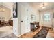 Welcoming entryway featuring hardwood floors, neutral walls, a wooden console table, and access to the dining area at 6792 E Briarwood Dr, Centennial, CO 80112