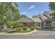 Inviting home with a well-manicured lawn, mature trees, and a charming front porch, enhancing its curb appeal at 6792 E Briarwood Dr, Centennial, CO 80112