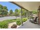 Inviting front porch with seating area and views of the well-manicured lawn and neighborhood at 6792 E Briarwood Dr, Centennial, CO 80112