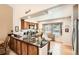 Modern kitchen boasts sleek granite countertops, wood cabinets, and an island with a breakfast bar, great for casual dining at 6792 E Briarwood Dr, Centennial, CO 80112