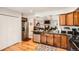 Contemporary kitchen with stainless steel appliances, granite countertops, and a functional layout, connecting to the adjacent living area at 6792 E Briarwood Dr, Centennial, CO 80112
