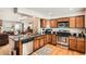 Well-appointed kitchen featuring wood cabinetry, stainless steel appliances, and granite countertops, perfect for culinary enthusiasts at 6792 E Briarwood Dr, Centennial, CO 80112