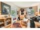 Cozy living room with hardwood floors, natural light, built-in shelving, and comfortable seating area at 6792 E Briarwood Dr, Centennial, CO 80112