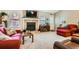 Cozy living room features a fireplace, neutral carpet, and bright windows, creating a welcoming atmosphere at 6792 E Briarwood Dr, Centennial, CO 80112