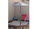 Fun sandbox area with beach chair, umbrella, and playful decorations at 6792 E Briarwood Dr, Centennial, CO 80112