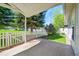 Covered back patio with a view of the fenced in yard with mature landscaping at 7870 Sunflower Green # 151, Frederick, CO 80530