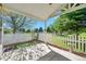 Backyard patio area overlooks park and features a white fence and mature trees at 7870 Sunflower Green # 151, Frederick, CO 80530