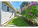 Landscaped backyard featuring lush green grass and vibrant lilac bushes at 7870 Sunflower Green # 151, Frederick, CO 80530