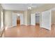 Neutral bedroom with a ceiling fan, hardwood floor, and multiple closets with a view to the bathroom at 7870 Sunflower Green # 151, Frederick, CO 80530