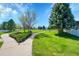 Scenic community park with walking paths, lush greenery, and mature trees at 7870 Sunflower Green # 151, Frederick, CO 80530