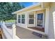 Inviting front porch with white picket fence, storm door, and views at 7870 Sunflower Green # 151, Frederick, CO 80530